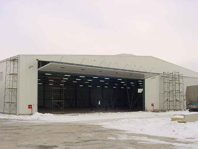 large bifold door fully opened on european aircraft hangar