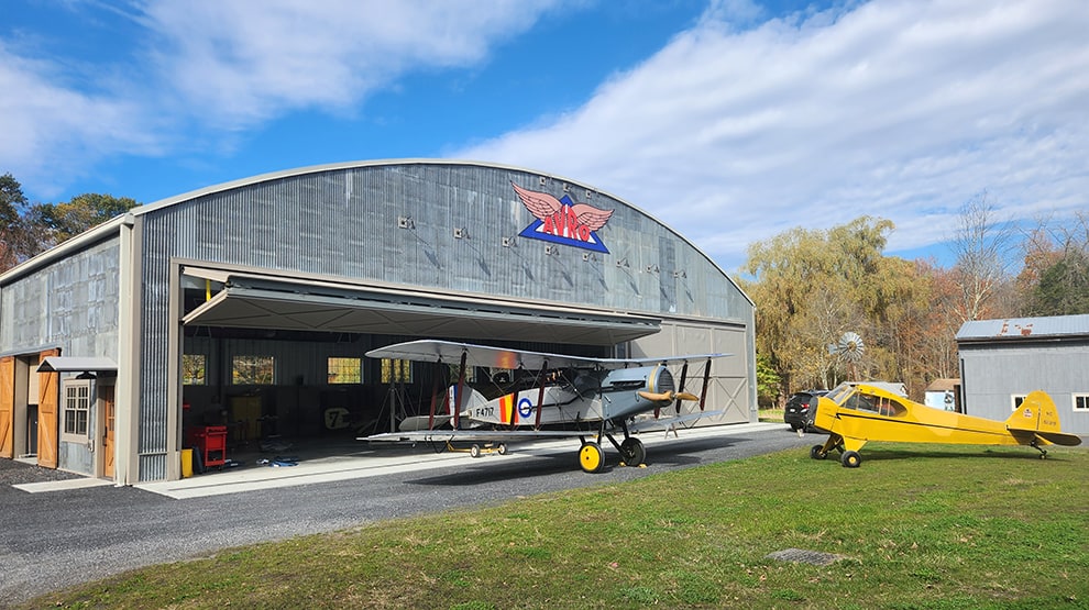 Old Rhinebeck Aerodrome AVRO hangar fitted with Schweiss bifold lift strap hangar door shown open Old Rhinebeck Aerodrome AVRO hangar fitted with Schweiss bifold lift strap hangar door shown open