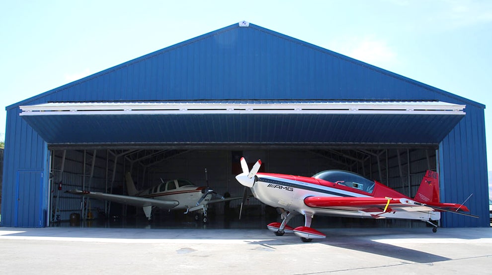 Schweiss bifold hangar door installed on blue steel hangar in Chile Schweiss bifold hangar door installed on blue steel hangar in Chile