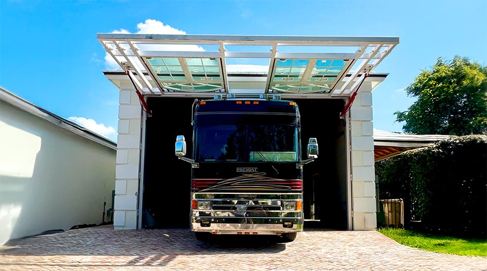 Schweiss glass hydraulic designer door installed on RV garage with an RV parked inside Schweiss glass hydraulic designer door installed on RV garage with an RV parked inside