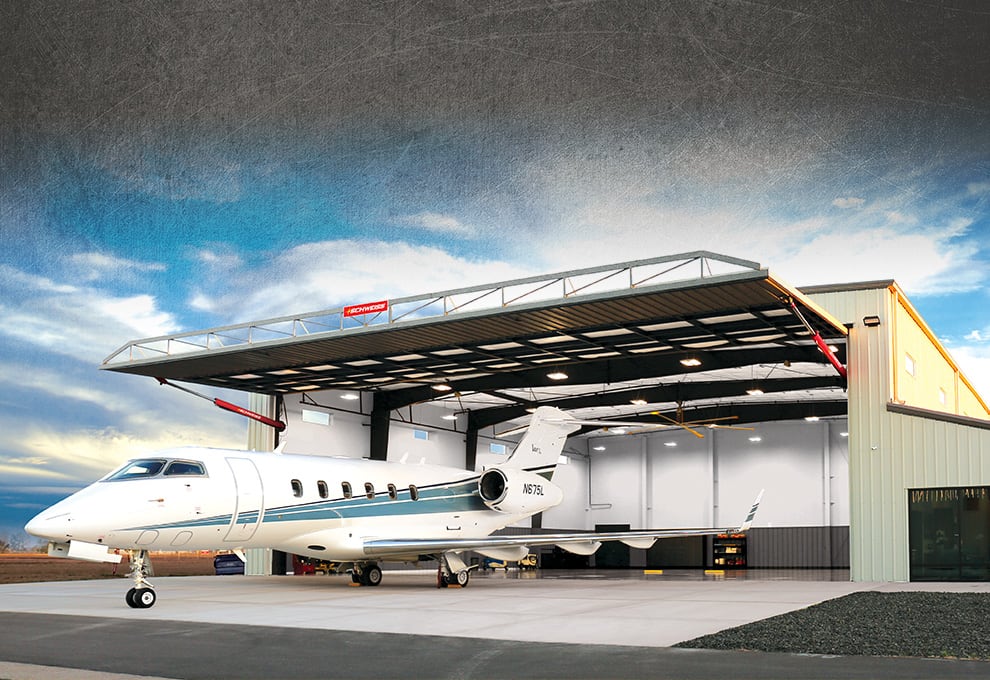 Hydraulic Door from Colorado Doors by Schweiss fitted on a hangar with a plane parked in front