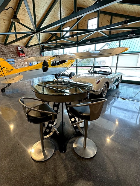 Don Smith Jr's plane and classic car parked inside his backyard hangar that's fitted with a Schweiss glass hydraulic door Don Smith Jr's plane and classic car parked inside his backyard hangar that's fitted with a Schweiss glass hydraulic door