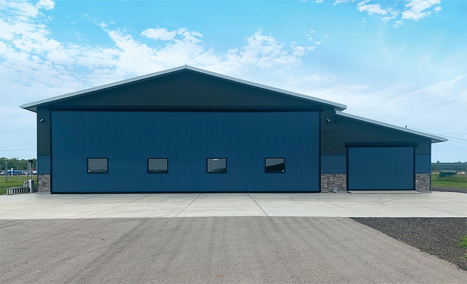 Exterior view of both Schweiss hydraulic doors fitted on the Econo Lumber hangar shown closed