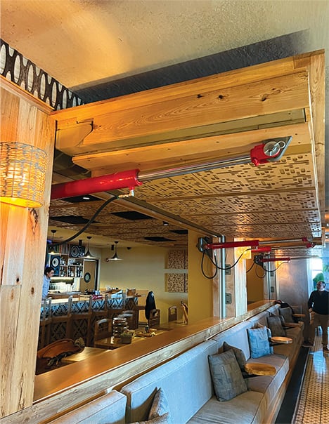 Two opened Schweiss hydraulic doors used as a separator in Macanda Mexican Restaurant viewed from the left side
