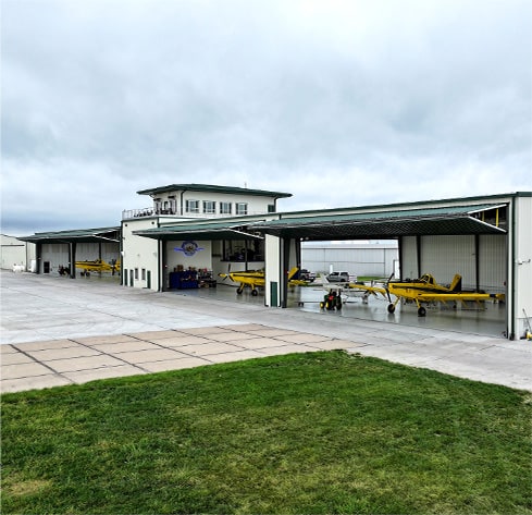 Exterior view from right of Nebraskaland Hangar fitted with multiple Schweiss bifold doors shown open Exterior view from right of Nebraskaland Hangar fitted with multiple Schweiss bifold doors shown open