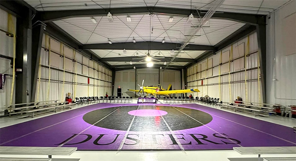 Interior view from front of Dusters logo on the ground inside Nebraskaland Hangar, one plane parked inside Interior view from front of Dusters logo on the ground inside Nebraskaland Hangar, one plane parked inside