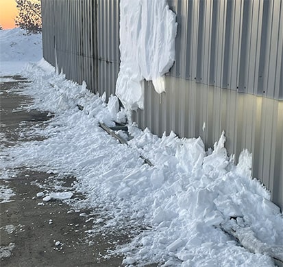 Hydraulic door with external truss covered in snow