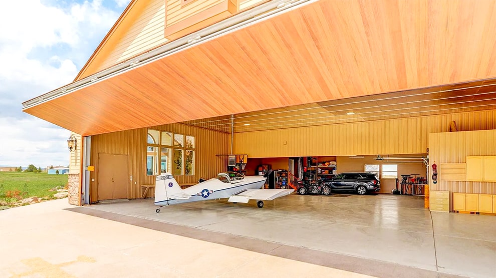 Schweiss liftstrap bifold hangar home door installed on hangar home in Colorado viewed from outside Schweiss liftstrap bifold hangar home door installed on hangar home in Colorado viewed from outside