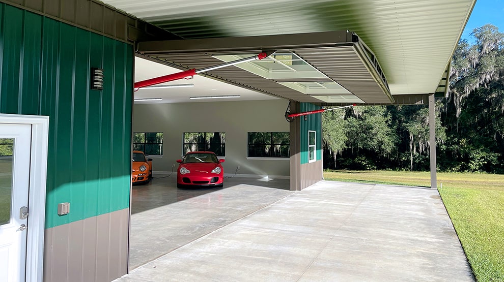 Schweiss residential hydraulic door installed on luxury car garage shown open Schweiss residential hydraulic door installed on luxury car garage shown open