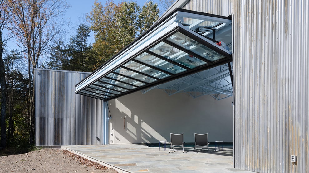 Closeup view of Schweiss bifold glass door installed on New York boathouse shown open Closeup view of Schweiss bifold glass door installed on New York boathouse shown open