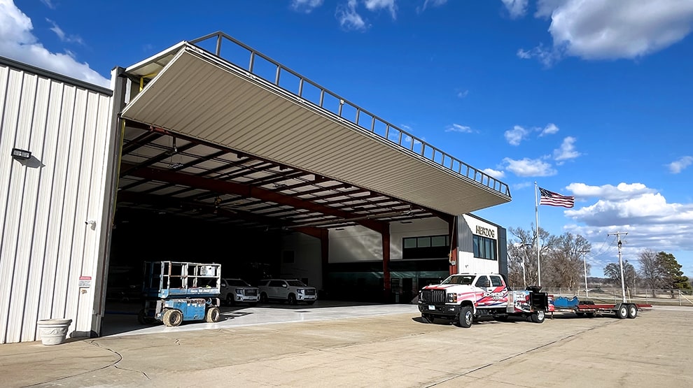Exterior view of Schweiss bifold hangar door that was purchased as an upgrade for Herzog Contractings building Exterior view of Schweiss bifold hangar door that was purchased as an upgrade for Herzog Contractings building