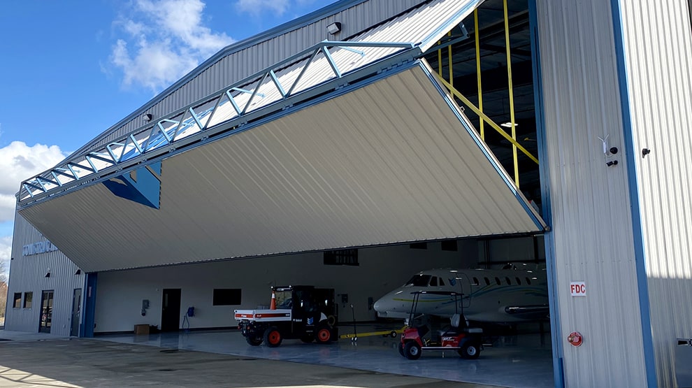 Schweiss bifold hangar door shown opening on hangar owned by SEI Construction Schweiss bifold hangar door shown opening on hangar owned by SEI Construction