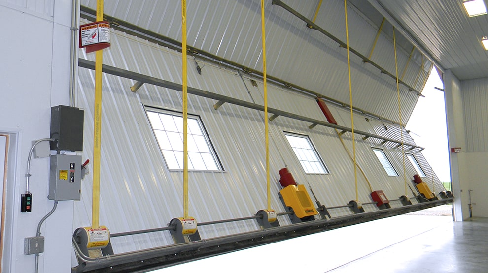 Closer look at Schweiss lift straps from the interior side of a bifold door Closer look at Schweiss lift straps from the interior side of a bifold door