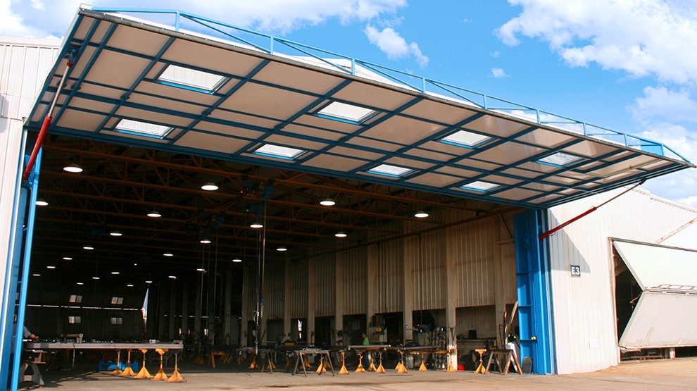 Schweiss hydraulic hangar door fitted on one of the Schweiss factory shops where other Schweiss hydraulic and bifold doors are built Schweiss hydraulic hangar door fitted on one of the Schweiss factory shops where other Schweiss hydraulic and bifold doors are built