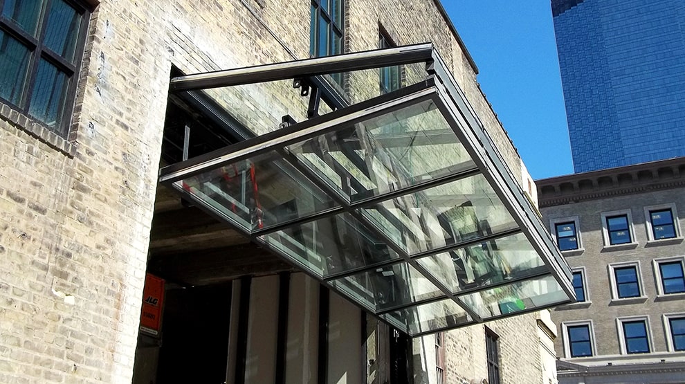 Schweiss bifold glass designer door isntalled on a building in Minneapolis shown open Schweiss bifold glass designer door isntalled on a building in Minneapolis shown open