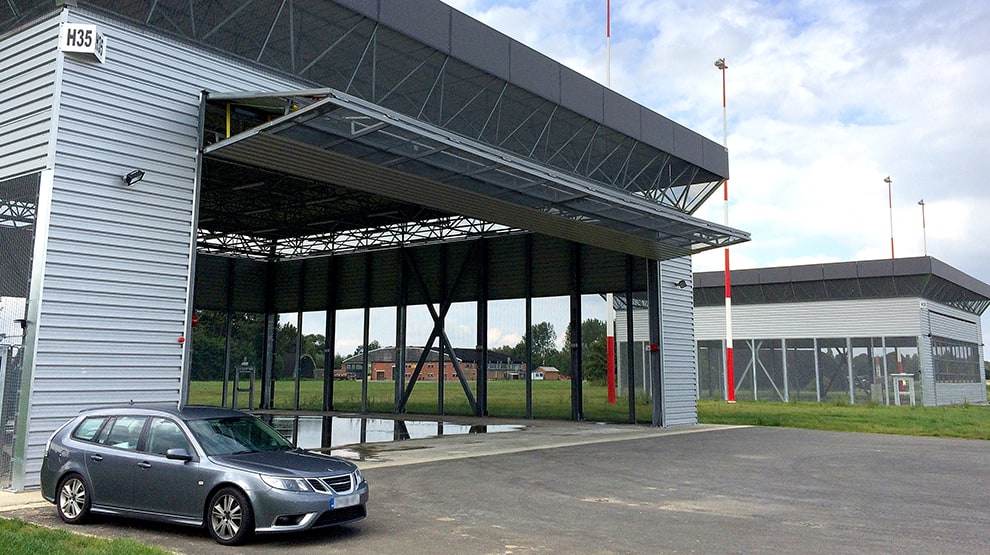 Belgian Airforce military helicopter hangar utilizing strong Schweiss liftstrap bifold door Belgian Airforce military helicopter hangar utilizing strong Schweiss liftstrap bifold door