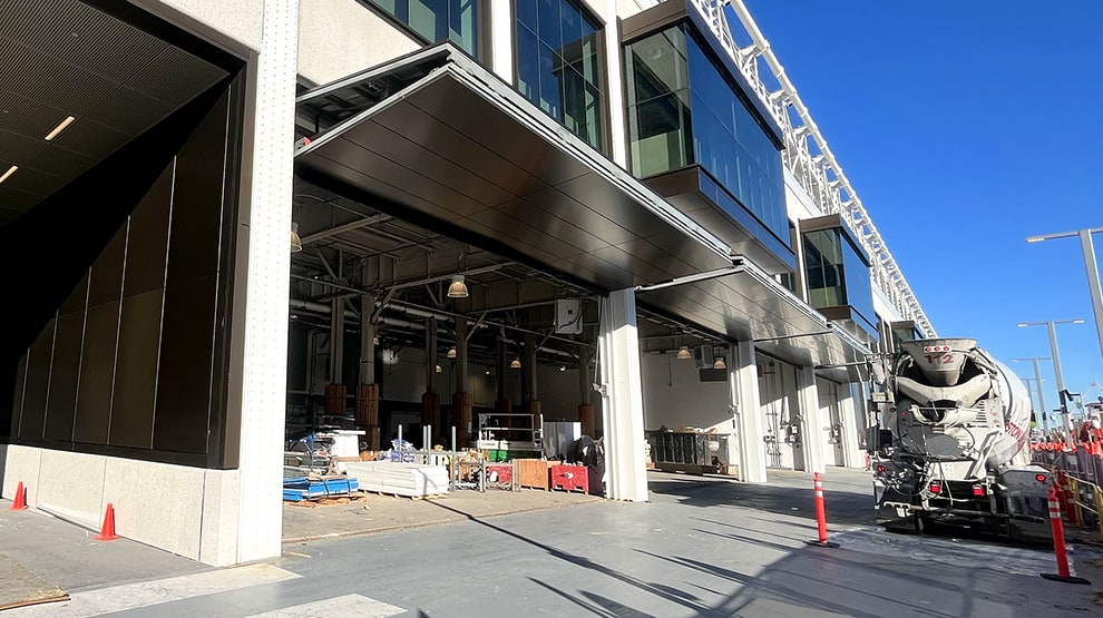 Multiple Schweiss bifold doors installed along a waterfront ferry shop Multiple Schweiss bifold doors installed along a waterfront ferry shop