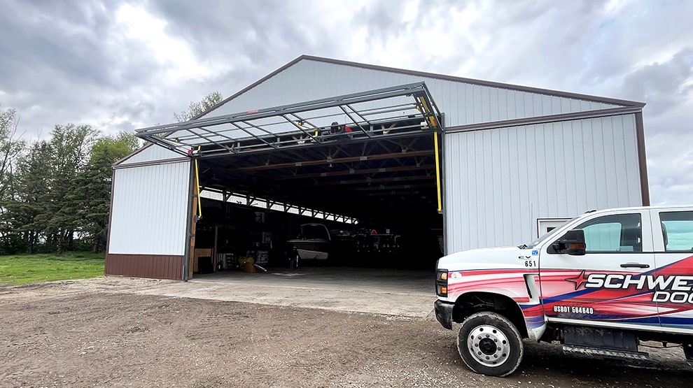 Schweiss installer truck parked in front of recent installation of a bifold door frame Schweiss installer truck parked in front of recent installation of a bifold door frame