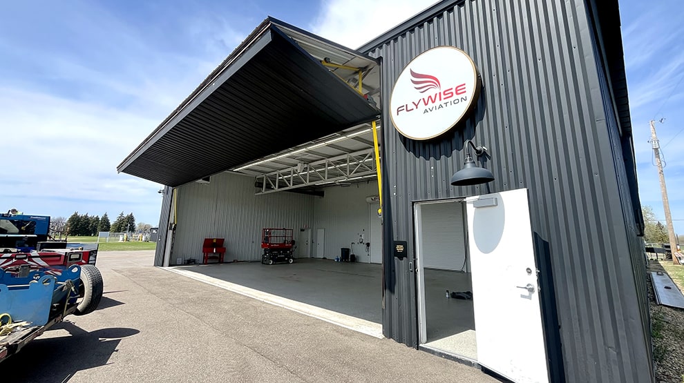 Schweiss bifold hangar door installed on Flywise Aviation hangar shown open Schweiss bifold hangar door installed on Flywise Aviation hangar shown open