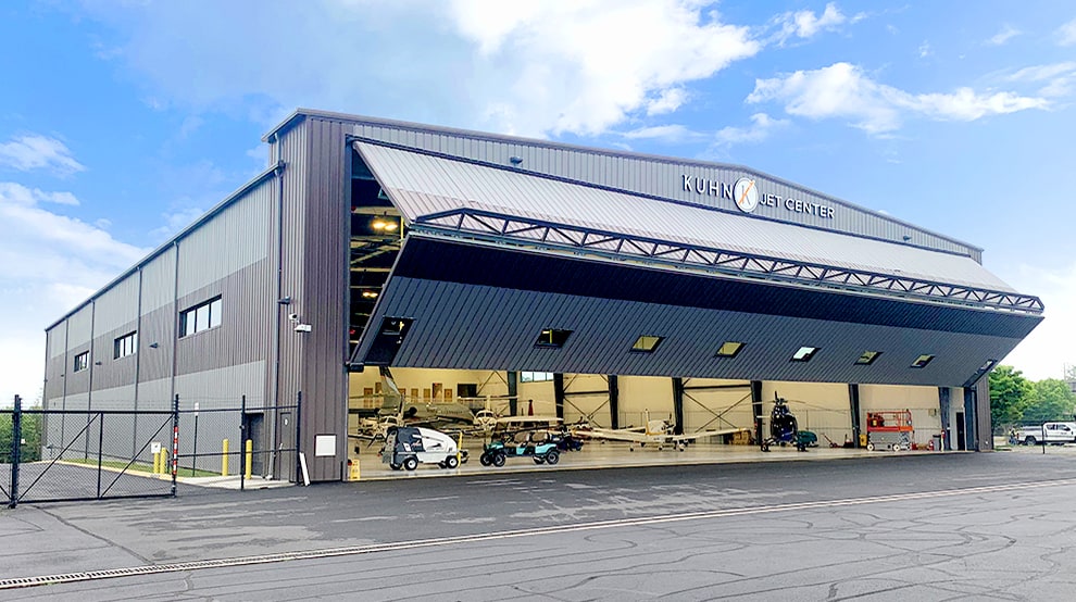 Schweiss bifold aircraft hangar door installed on Kuhn Jet Center shown halfway open Schweiss bifold aircraft hangar door installed on Kuhn Jet Center shown halfway open
