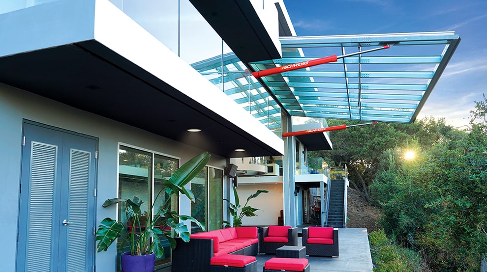 Exterior view of Schweiss hydraulic glass door used on luxurious home as a large moving glass wall Exterior view of Schweiss hydraulic glass door used on luxurious home as a large moving glass wall