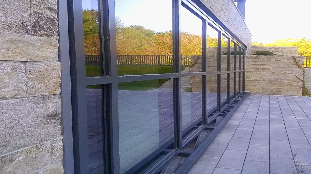 Schweiss hydraulic glass door installed on garage of luxury home shown closed Schweiss hydraulic glass door installed on garage of luxury home shown closed