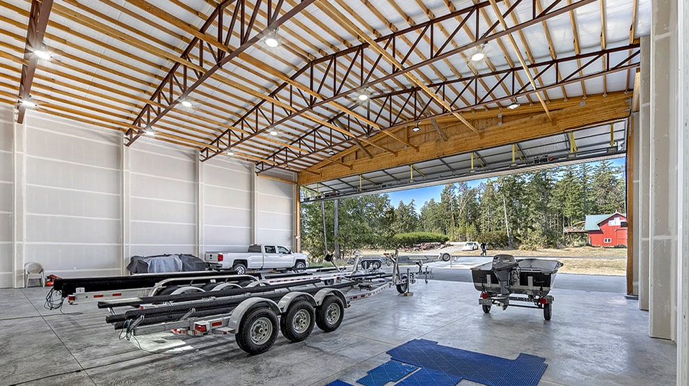 Interior view of large hangar storing multiple trailers, including a Schweiss bifold liftstrap door Interior view of large hangar storing multiple trailers, including a Schweiss bifold liftstrap door