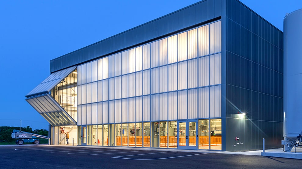 Schweiss glass bifold door installed on a commercial building shown opening Schweiss glass bifold door installed on a commercial building shown opening