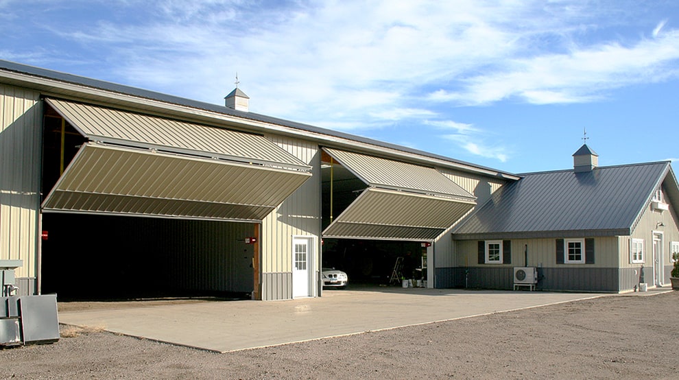Two patented Schweiss bifold liftsrap doors installed on a farm shed Two patented Schweiss bifold liftsrap doors installed on a farm shed