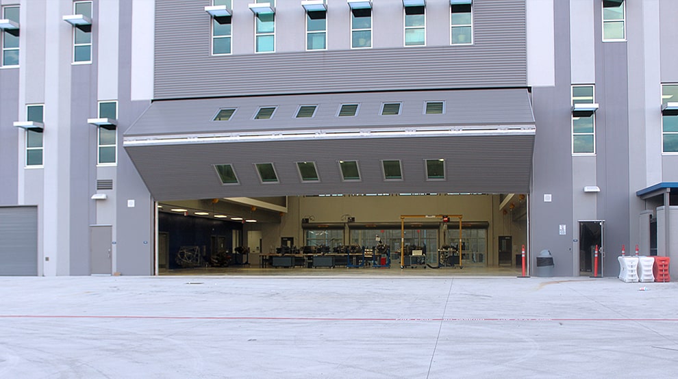 Sterling Aviation High School hangar fitted with Schweiss bifold hangar door with 12 built-in windows Sterling Aviation High School hangar fitted with Schweiss bifold hangar door with 12 built-in windows