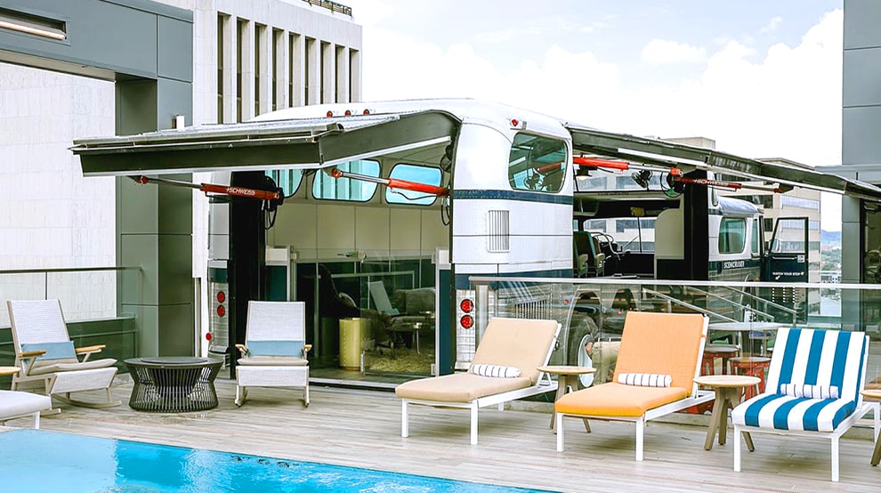 Two Schweiss hydraulic designers doors installed on Bobby Hotel bus rooftop shown open Two Schweiss hydraulic designer doors installed on Bobby Hotel bus rooftop shown open