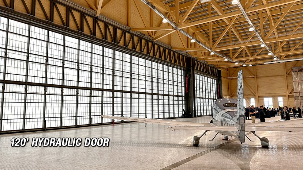 Smaller plane parked inside hangar fitted with large 120ft hydraulic hangar door from Schweiss Smaller plane parked inside hangar fitted with large 120ft hydraulic hangar door from Schweiss