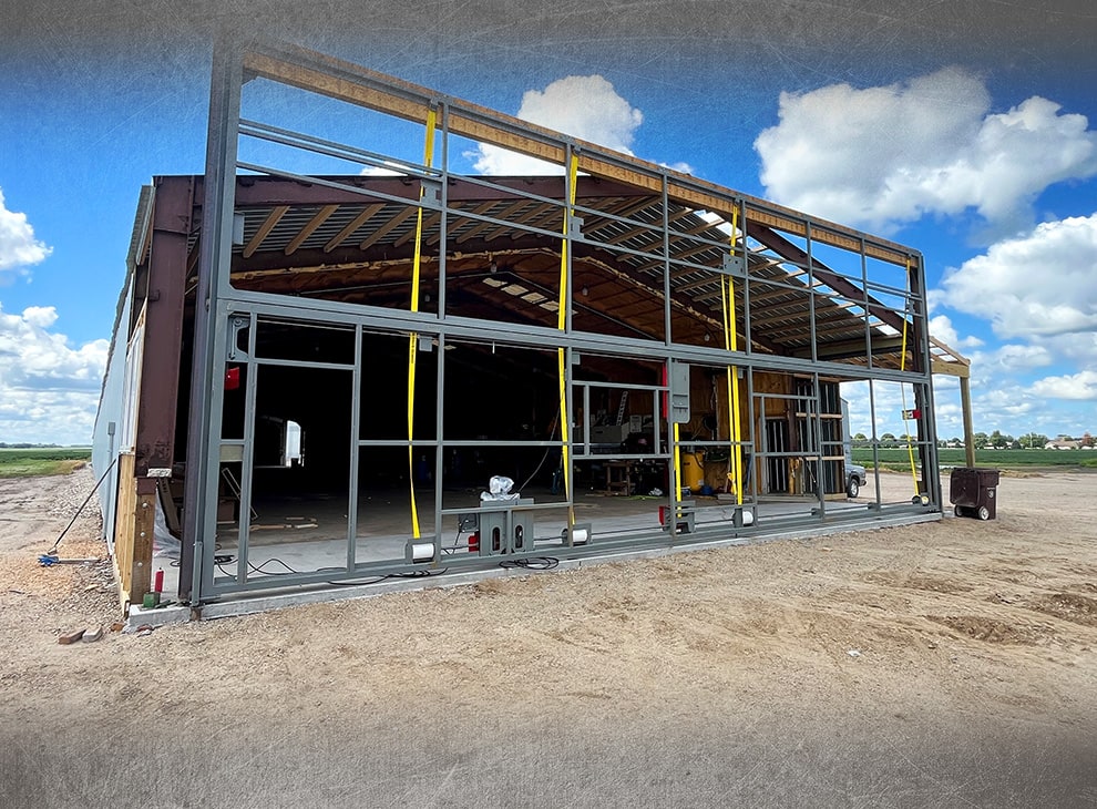 Arkansas bifold frame by Schweiss being installed on building