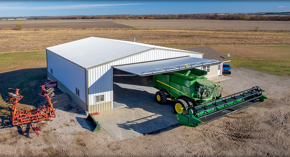 Arkansas hydraulic door by Schweiss fitted on a farm shop that stores a combine