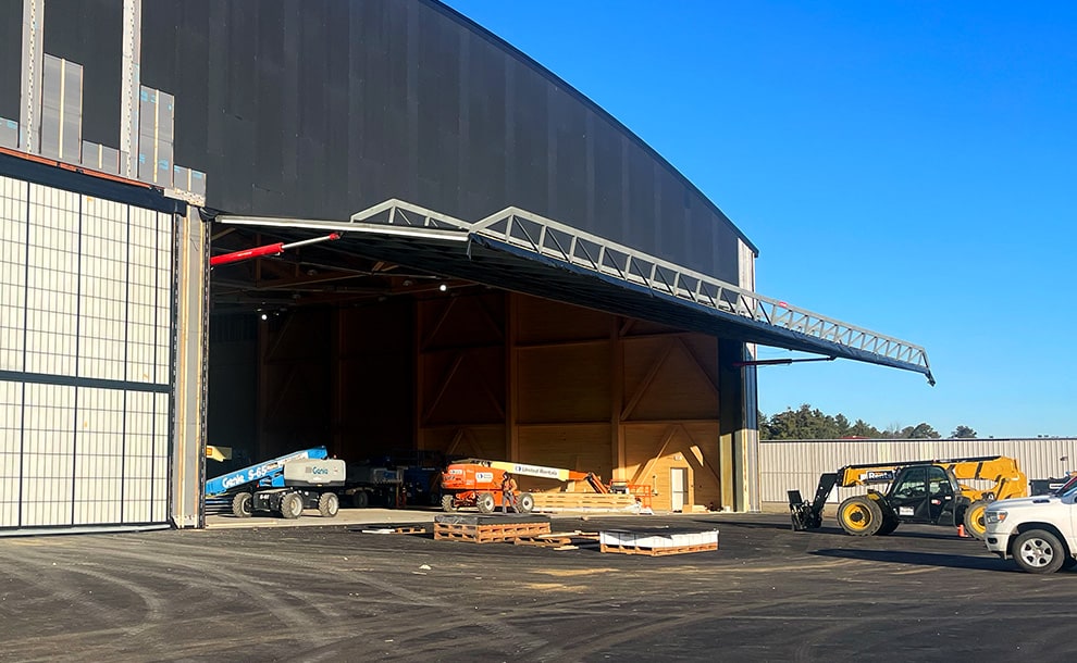 California hydraulic door by Schweiss being installed on hangar