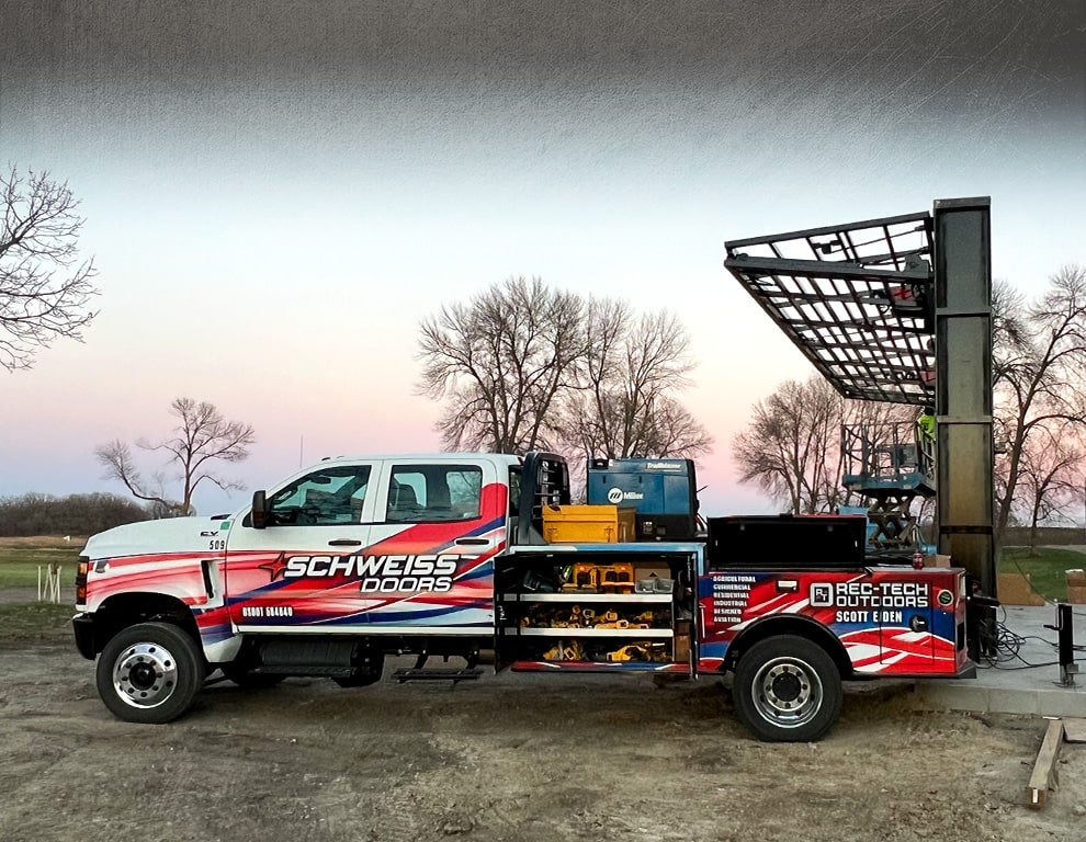 Montana bifold frame by Schweiss behind parked installer truck