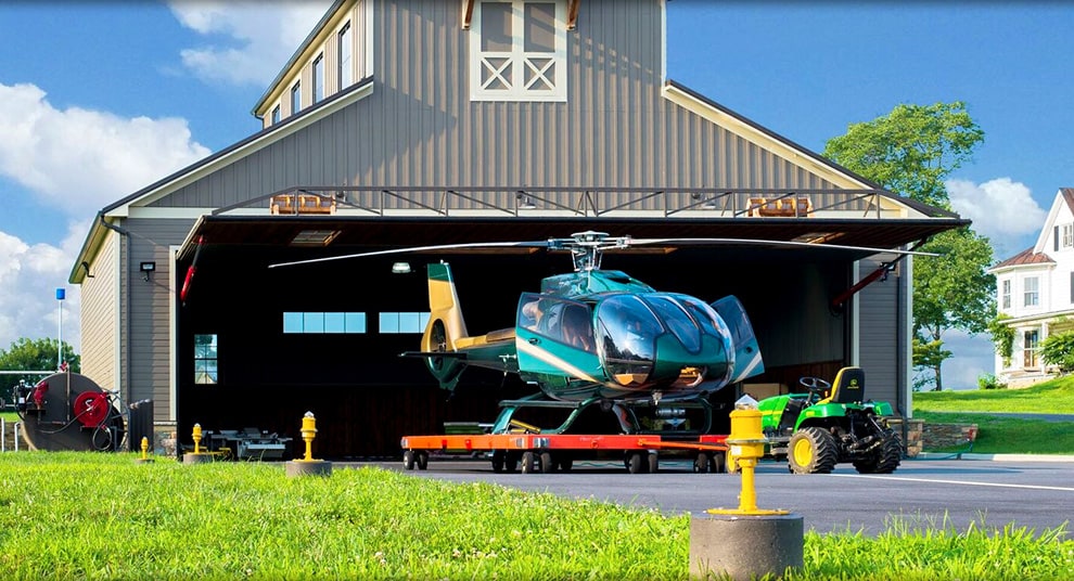 Ohio hydraulic door by Schweiss fitted on a hangar behind helicopter